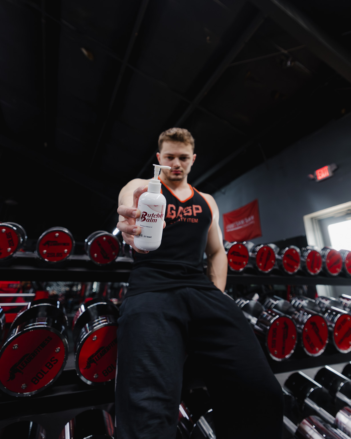 Athlete holding Butcher Balm in the gym