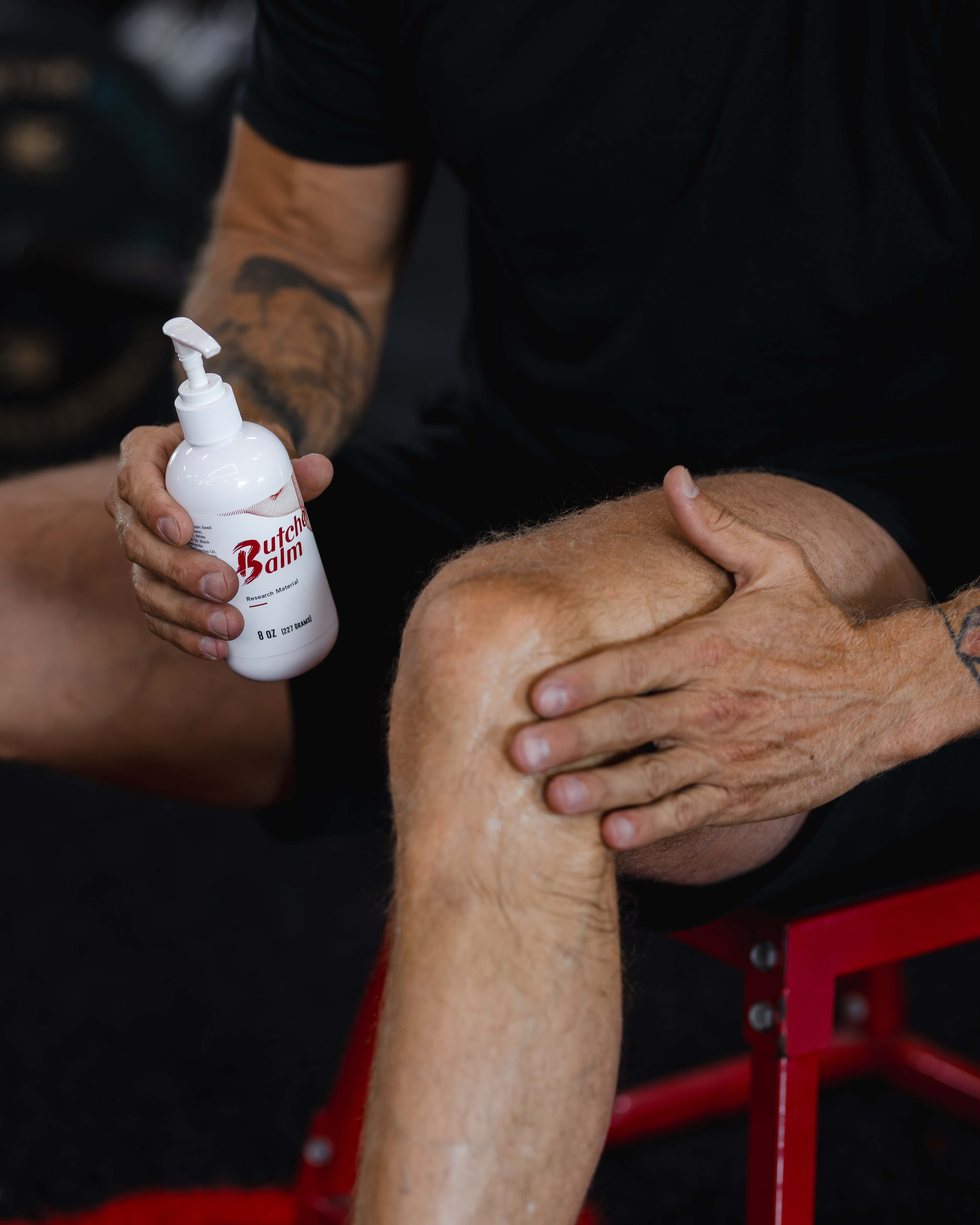 Massaging Butcher Balm into the knee