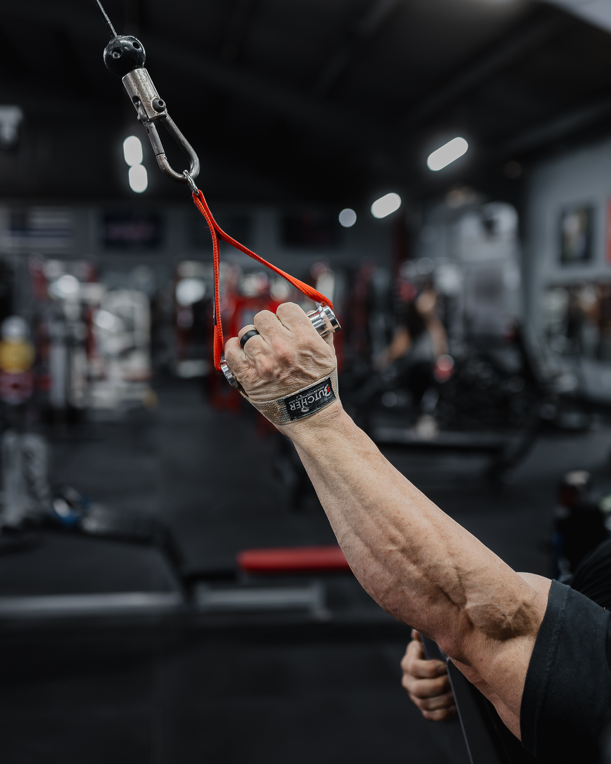 Athlete using red Butcher Hooks on a cable machine